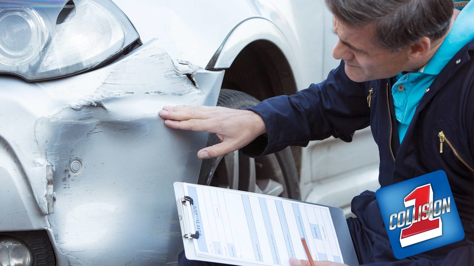 Man inspecting auto body damage holding a clip board while preparing an estimate after a collision.