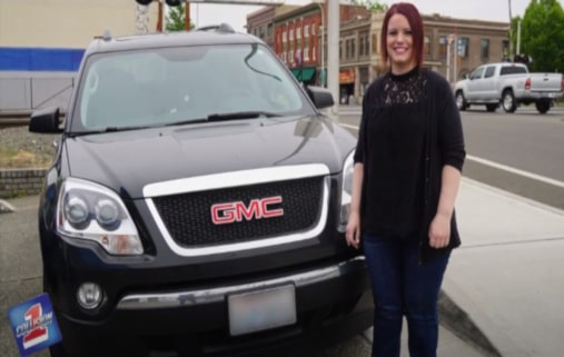 Smiling young lady standing next to her GMC vehical with a collision 1 logo overlay